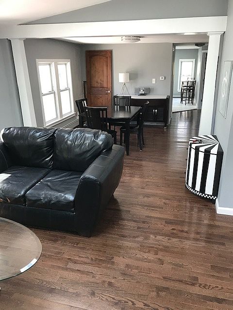 Living room looking into the dining room and kitchen with continuous hardwood floors