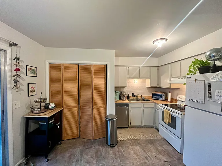 Washer and dryer behind doors - comes with unit.