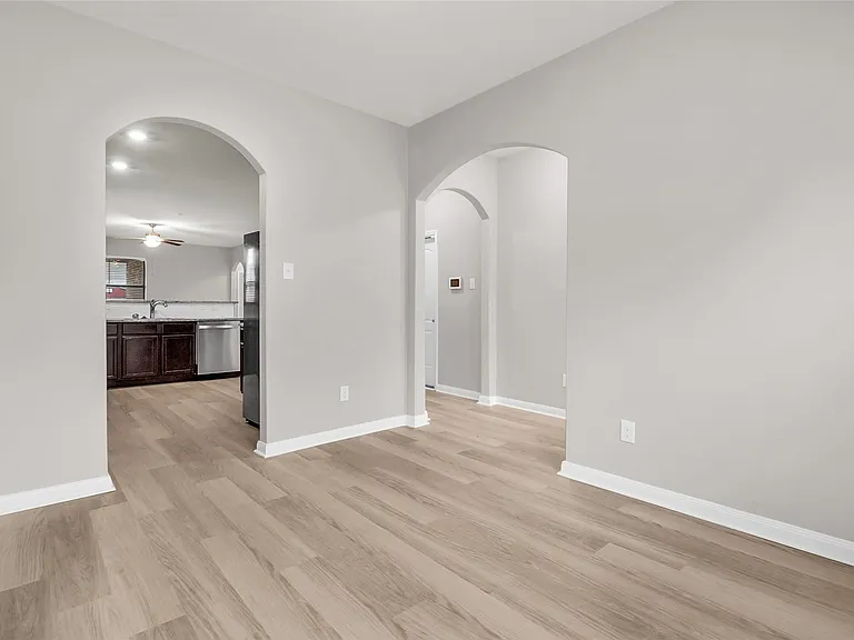 View from dining area to the kitchen and main entry.