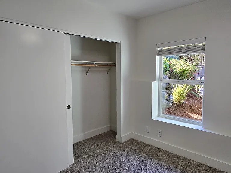 North bedroom. Beautiful side garden and a huge closet!