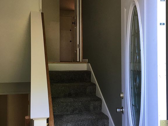 Staircase going up leads to Unit 1 (3BR/2BA). Staircase going down leads to Unit 2 (2BR/1BA). Both units have secure interior front doors to clearly separate the two units.