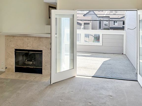 Living room with french doors that lead out to a very large balcony/deck