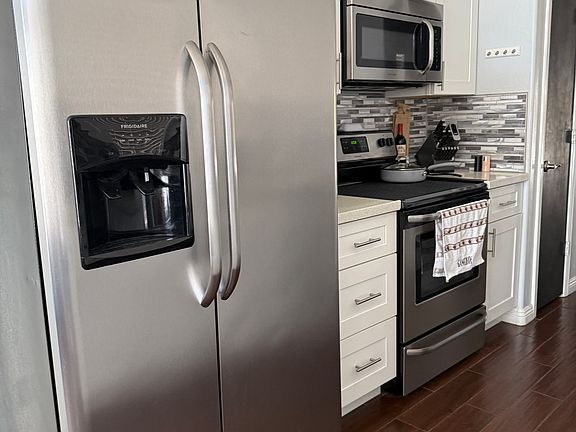Water and ice dispenser in fridge, stainless appliances, pantry