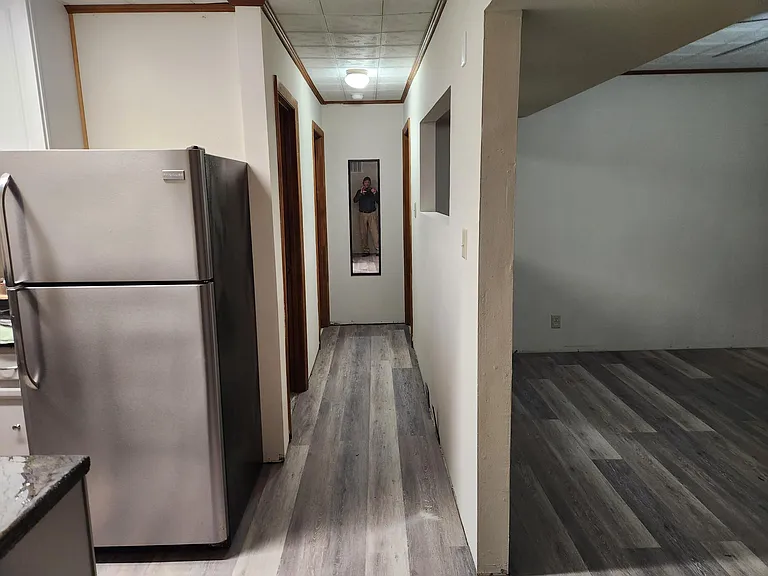 Hall. First door on the left is the bathroom. Doors at the end of the hall are bedroom on the right, office on the left