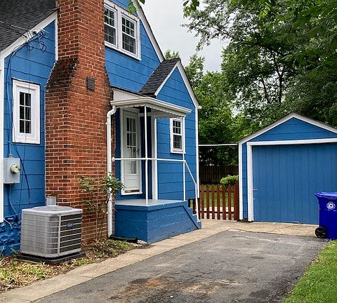 Side with driveway, garage, gate to backyard, side door into kitchen