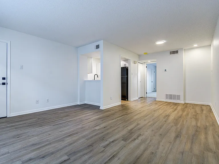 A bright living room with vinyl floor is shown at ReNew on Cantrell.