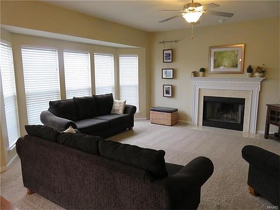 Great room with triple bay window, cozy wood-burning fireplace. Newer carpet throughout entire home.
