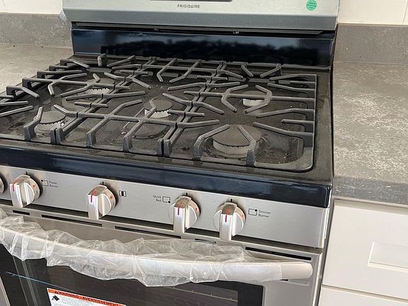 New gas stove with electric oven.