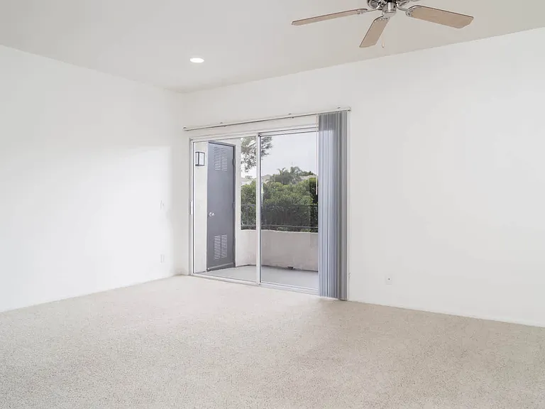 Carpeted Living Room with Balcony