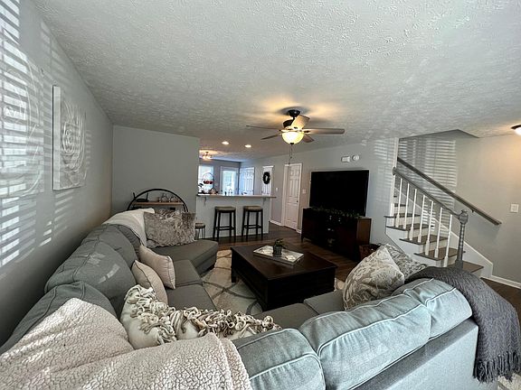 living room with big couch and 70in TV