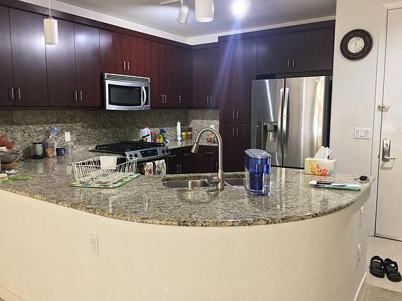 Modern kitchen with stainless steel appliances, granite top