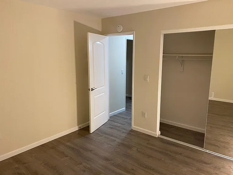 Bedroom, upgraded door and mirrored sliding closet door.