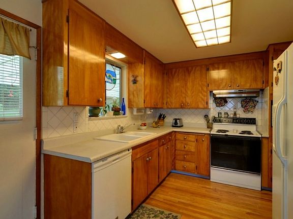 Back door off kitchen leads to a patio that runs the length of the house. So handy for backyard bar-b-ques and parties.