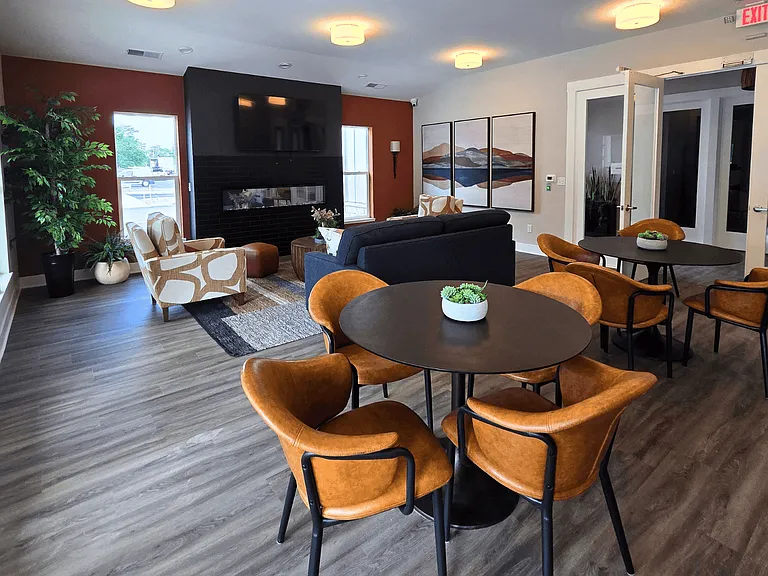 Clubhouse lounge area with seating, television, and fireplace at Greenwood Commons in Delaware, OH.