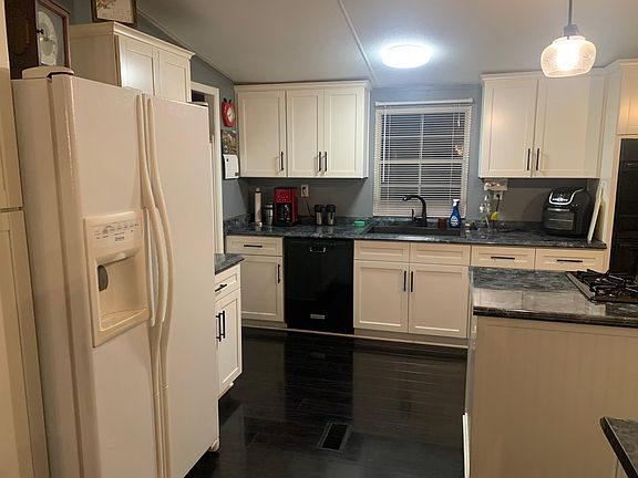 Engineered hardwood in the kitchen and beautiful crown molding atop the cabinets