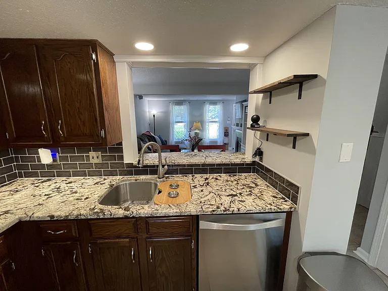 Kitchen with beautiful granite counter tops and real tile backsplash
