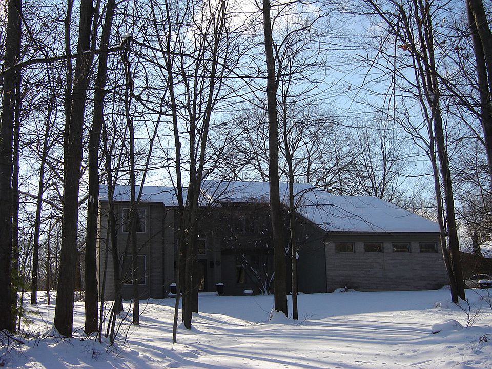 This captivating contemporary home is perfect for family and entertaining.  It features a luxurious master suite with spa shower, large jetted tub, and gas fireplace. Three additional bedrooms are bright and cheerful with generous closets. The great room, with its soaring 20 ft. ceiling, features a gas fireplace surrounded by floor-to-ceiling windows.  The kitchen has a center island with new cooktop, Corian counters, new wall oven/microwave combo and has loads of storage with slide-outs. The bathrooms are newly remodeled and updated with vessel sinks and granite counters. The cozy family room has a giant door-wall and wood-burning fireplace with built-ins on both sides.  An additional lower level family room features new carpeting, storage closets and an egress window. The unfinished side has a workshop and lots of shelving for storage. The backyard is a peaceful oasis with a brick patio and large 8 person hot tub. There is a playset, fire pit, and 10 x 10 shed.  Backs to a  meadow.