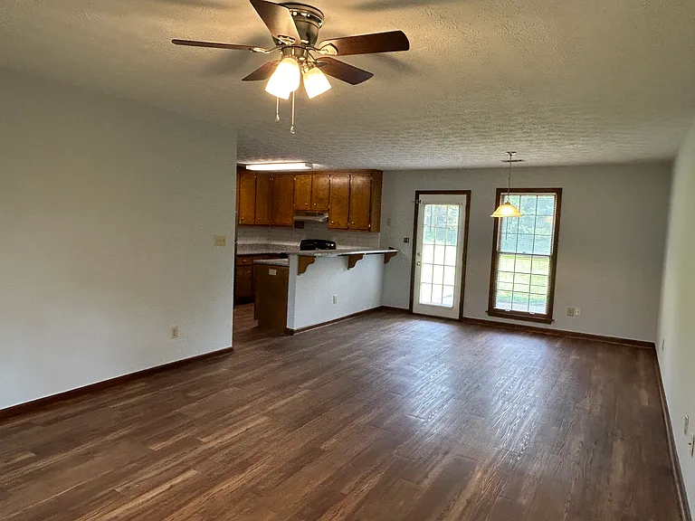 Standing at front door looking into living, dining, and kitchen spaces