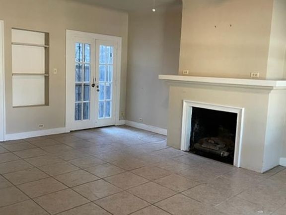 Living Room with Fireplace, Bookshelves and Rear Entry to Carport