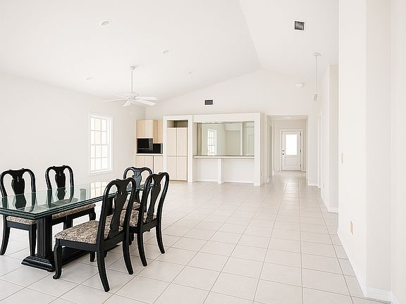 Dining opens to covered screened pstio and Great Room area.