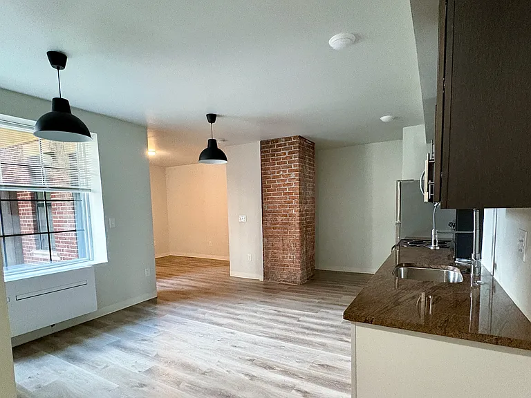 Expansive open floor plan with stylish industrial elements throughout, ready for your personal touch