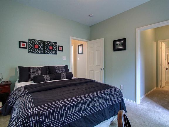First level guest suite with two closets, ensuite bath and access to fenced greenspace.