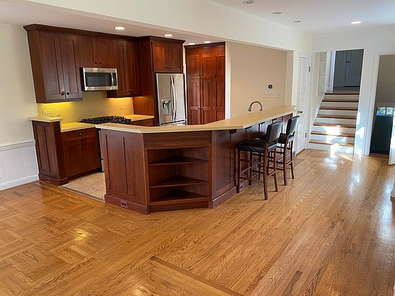Open Kitchen with Bar Stool Setup, Opens To Living Room and Dinning Room.