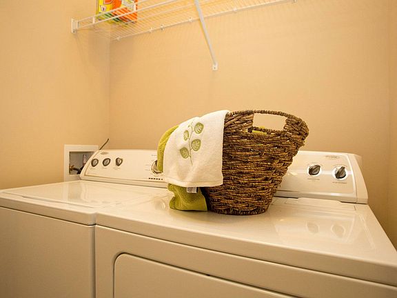 Enjoy in-home laundry with an efficient full size washer and dryer as well as storage shelf