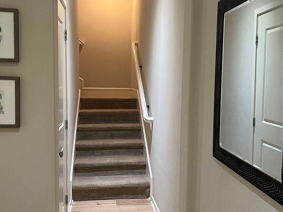 Landing at front door with stairs leading to main level