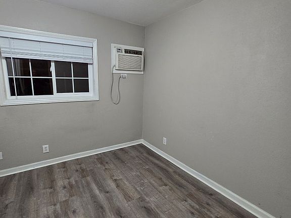 living area with wall unit heating and air