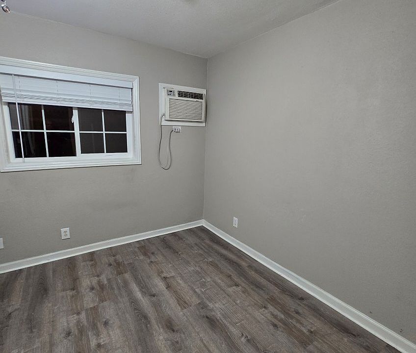 living area with wall unit heating and air