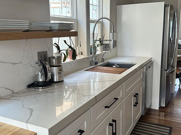 High end sink/faucet/dishwasher. New cabinets. Granite countertop. Floating shelves. Custom shelving (to the left of photo)
