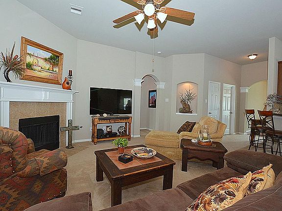 THE FAMILY ROOM IS STUNNING AND FEATURES ART NICHES, OPEN FLOOR PLAN, PLANT LEDGES AND ARCHED DOORWAYS