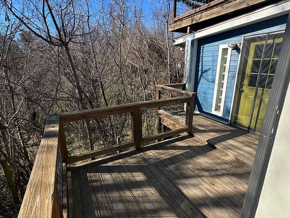 Deck and back entrance with view of the wooded, bird filled back yard. No neighbors to the back, very quiet.
