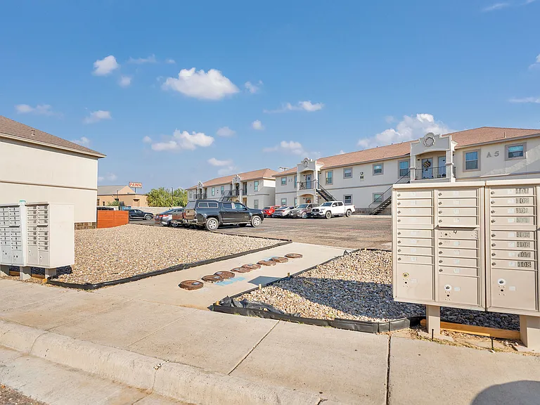 Stylish mailboxes are positioned before the Merida Vista Apartments, reflecting the upscale architecture in Laredo, Texas