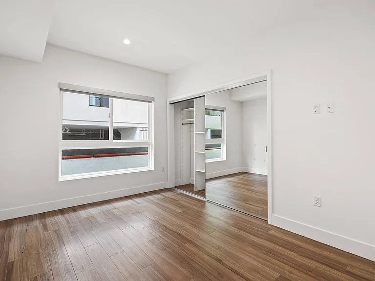 Bedroom with Mirrored Closet with Shelving
