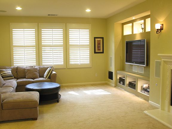 Open living room floor plan to adjoining chef's kitchen. Built-in entertainment center with in-wall/in-ceiling surround sound speakers. Gas fireplace.