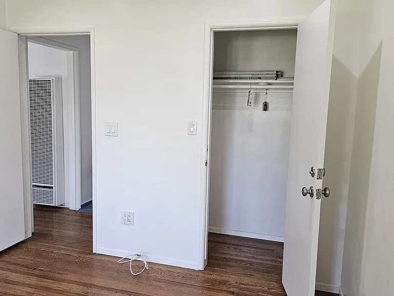 Bedroom, highlighting entrance to closet.