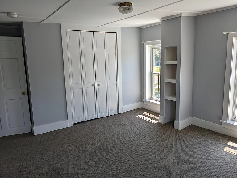 Master bedroom with large closet and built in shelving