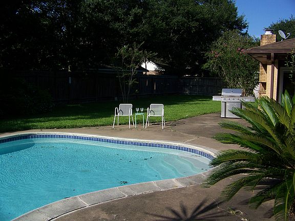 Backyard surrounded by trees