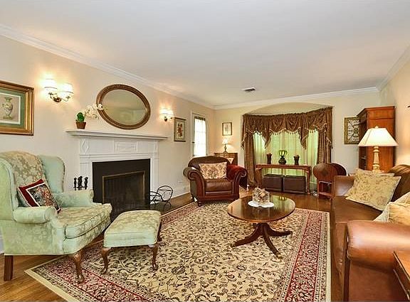 Living Room with fireplace and 2 separate doors to brick Veranda