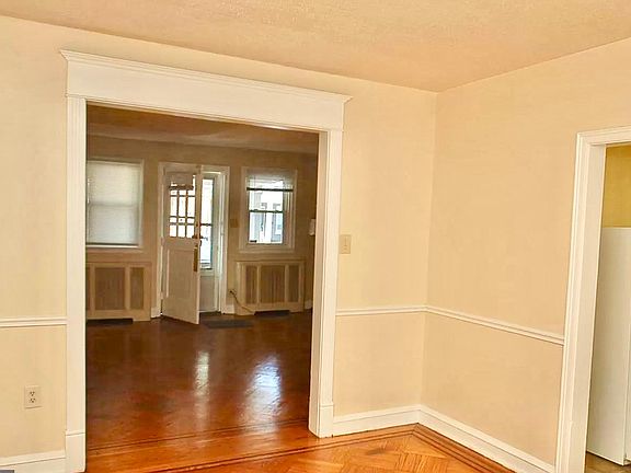 Image of the Living Room from the Dining Room. Kitchen can be seen on the right.