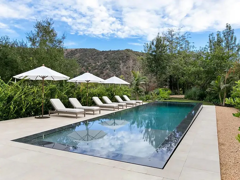 Zero edge pool makes this backyard space great for entertainment and exercise alike.