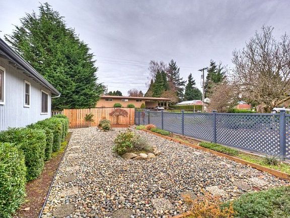 Rocks over ground mat in front yard, grass could easily be replaced.