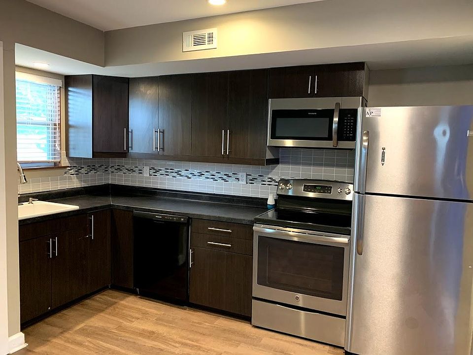 Unit 1 remodeled kitchen featuring upgraded cabinets, stainless steel appliances, and tiled backsplash