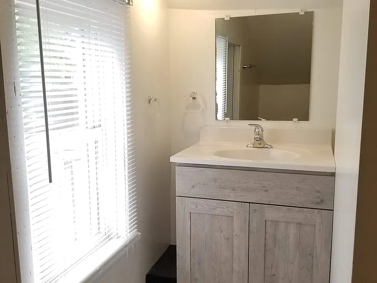 Upstairs Bathroom Vanity. Balcony deck located off bathroom.