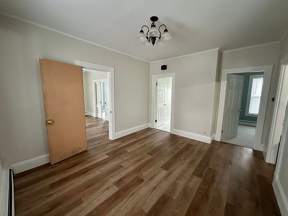 Dining Room with access to secondary bedroom (right), stairway to third floor (center), and living room (left)