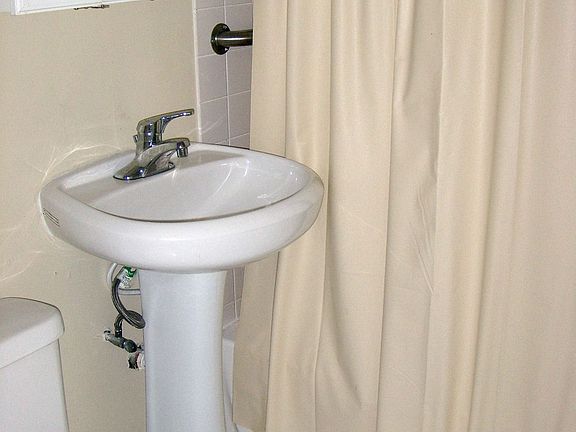 Sparkling clean remodeled bath with tiled floors.