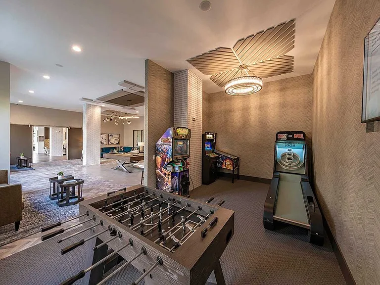 East building resident lounge with foosball table and arcade games