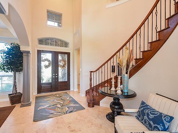 A view from the entry from inside the home. Note the beautiful wrought iron spindles on the staircase.